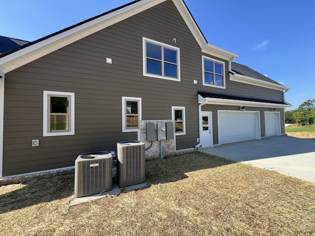 back of house with central AC unit