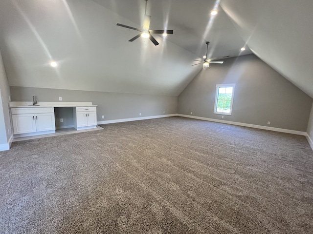 additional living space featuring carpet flooring, vaulted ceiling, sink, and ceiling fan