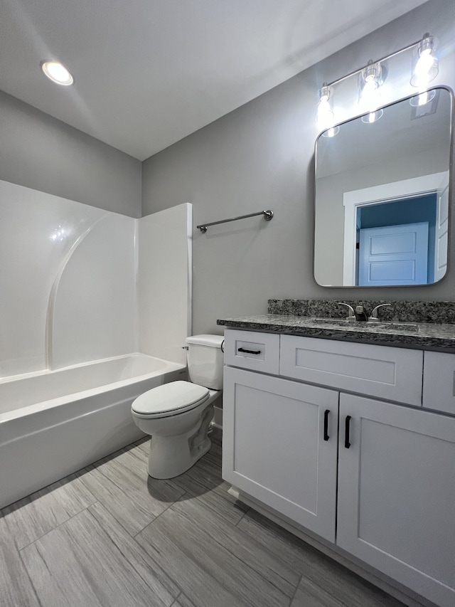 full bathroom featuring vanity, toilet, and  shower combination