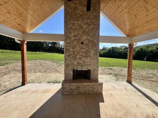 view of patio featuring an outdoor brick fireplace