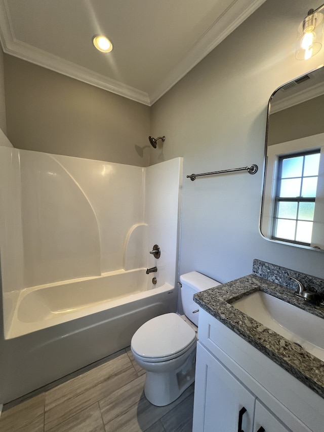 full bathroom featuring vanity, wood-type flooring, shower / bathing tub combination, crown molding, and toilet