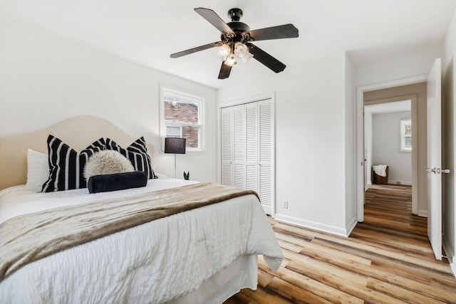 bedroom featuring ceiling fan, a closet, and hardwood / wood-style floors