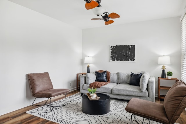 living room with ceiling fan and wood-type flooring