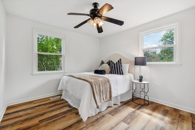 bedroom with ceiling fan and hardwood / wood-style floors