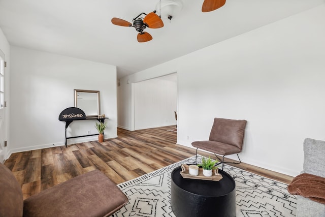 living area with ceiling fan and hardwood / wood-style floors