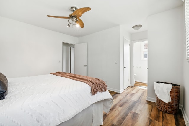 bedroom with light hardwood / wood-style floors, ensuite bath, and ceiling fan