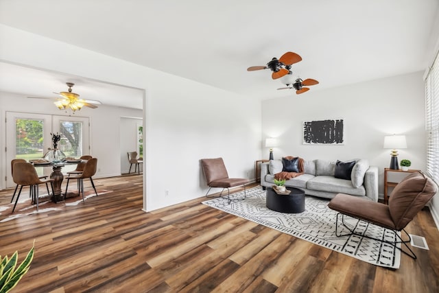 living room with wood-type flooring, ceiling fan, and french doors