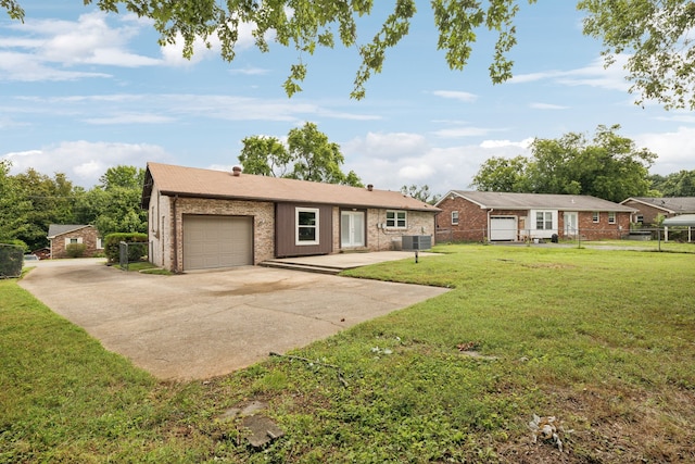 ranch-style house with a garage, central AC, and a front yard