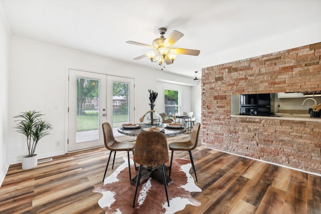 dining area featuring ceiling fan, hardwood / wood-style flooring, sink, and a wealth of natural light