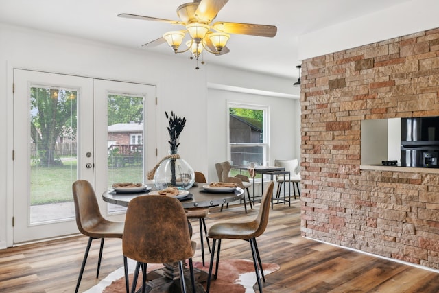 dining space with ceiling fan, french doors, hardwood / wood-style floors, and a wealth of natural light