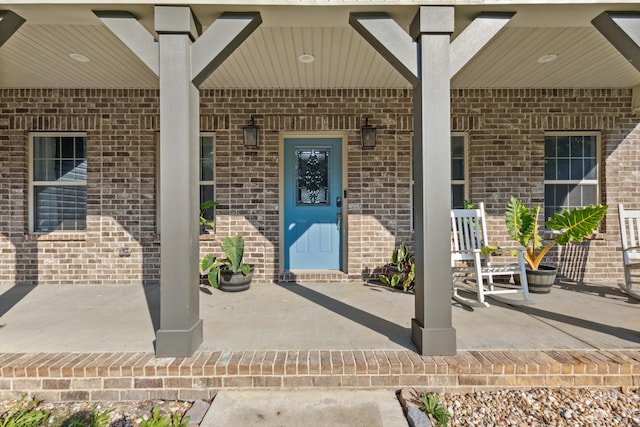 view of exterior entry with covered porch