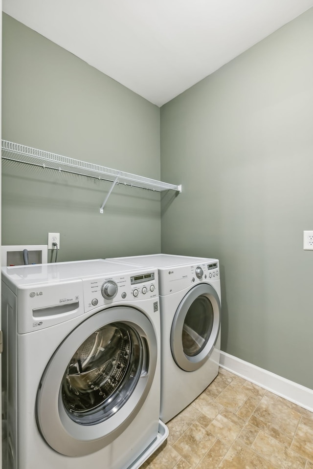 washroom featuring washing machine and clothes dryer