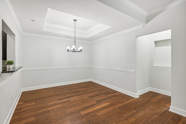 unfurnished dining area featuring an inviting chandelier, a raised ceiling, dark hardwood / wood-style floors, and ornamental molding