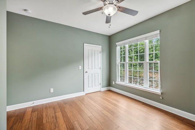 spare room featuring light hardwood / wood-style flooring and ceiling fan