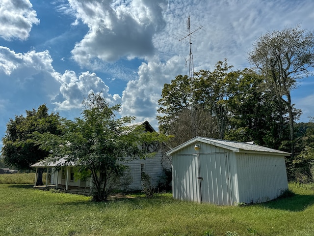 view of outbuilding featuring a lawn