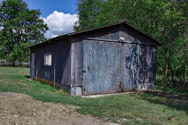 view of outbuilding featuring a lawn