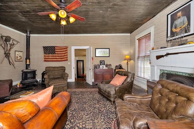 395 Case Rd, Prospect, TN 38477 - living area with a ceiling fan, a wood stove, wood walls, and wood finished floors