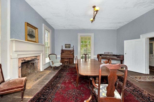 dining space with plenty of natural light and a fireplace