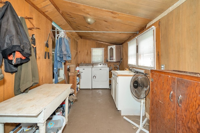 laundry room featuring wooden ceiling, washer and clothes dryer, wood walls, and cabinets