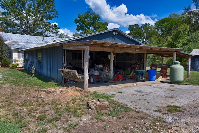 395 Case Rd, Prospect, TN 38477 - view of property exterior with board and batten siding, a pole building, an outbuilding, and a metal roof