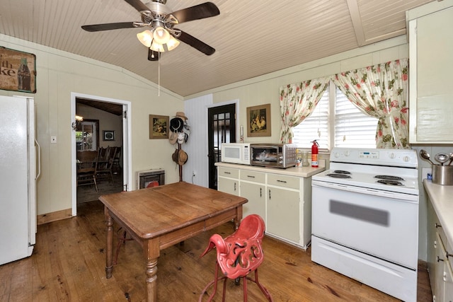 kitchen featuring heating unit, light wood-type flooring, vaulted ceiling, white appliances, and ceiling fan