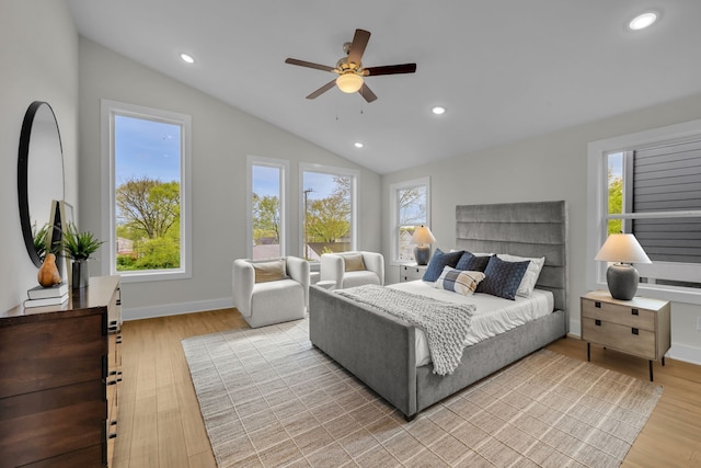 bedroom with ceiling fan, vaulted ceiling, and light hardwood / wood-style floors