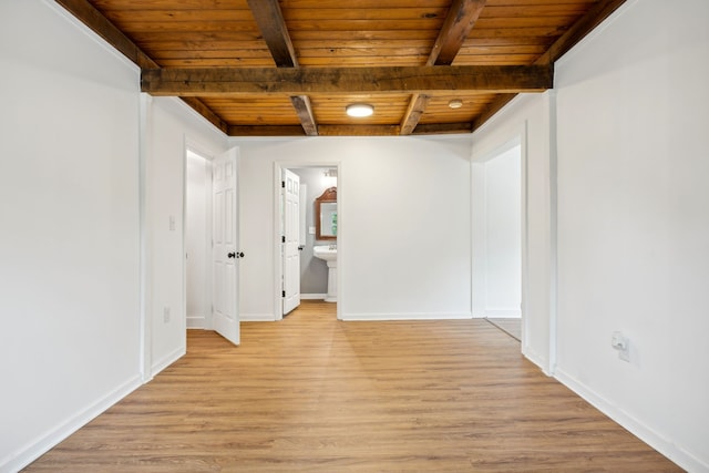 interior space with wood ceiling, light hardwood / wood-style floors, and beamed ceiling