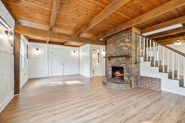 unfurnished living room featuring beamed ceiling, light wood-type flooring, and wood ceiling