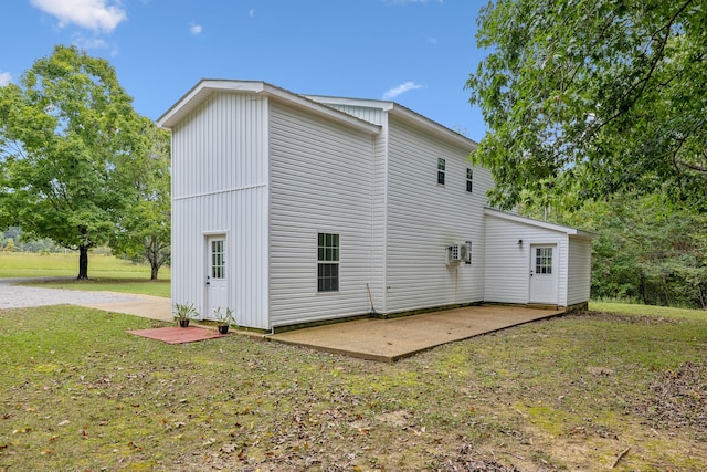 rear view of property with a lawn and a patio area