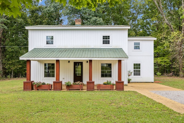 modern farmhouse style home with covered porch and a front yard