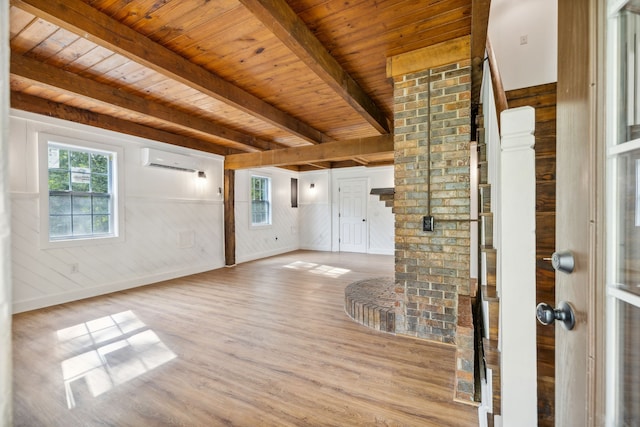 unfurnished living room with wood ceiling, light hardwood / wood-style floors, beam ceiling, wooden walls, and a wall mounted air conditioner