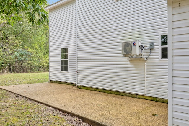 view of side of home with a patio and ac unit