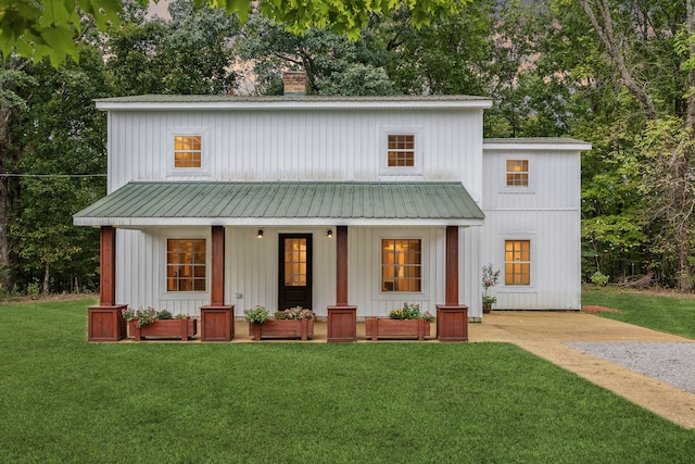 modern farmhouse style home with covered porch and a front yard