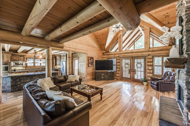 living room featuring wooden ceiling, light hardwood / wood-style floors, beamed ceiling, and french doors