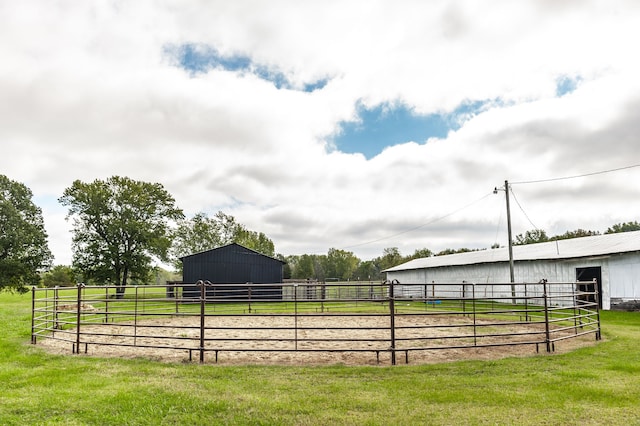 view of yard with a rural view and an outbuilding