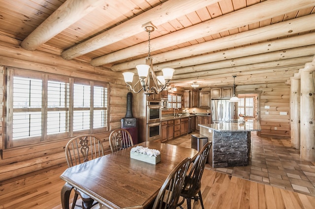 dining area with a chandelier, light hardwood / wood-style floors, sink, beam ceiling, and wooden ceiling