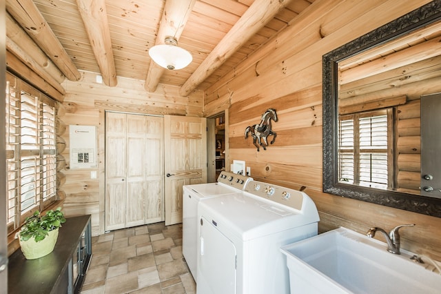 washroom featuring wooden walls, sink, washer and dryer, and wooden ceiling