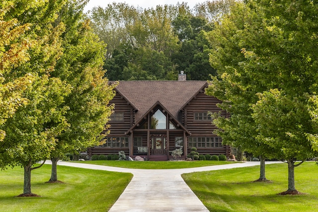 back of house with a lawn