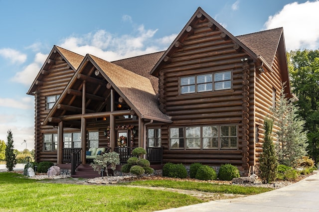 view of front of property with a front yard and covered porch