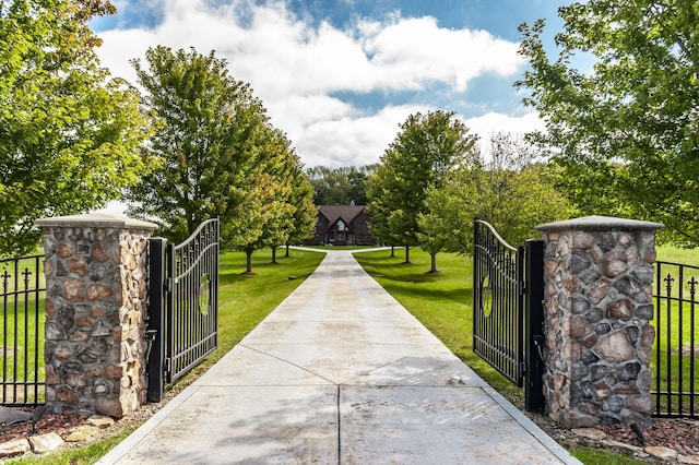 view of gate featuring a yard