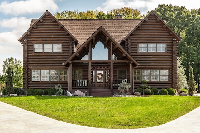 back of property with a porch and a yard