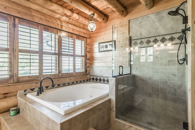 bathroom with a wealth of natural light, beam ceiling, wooden ceiling, and separate shower and tub