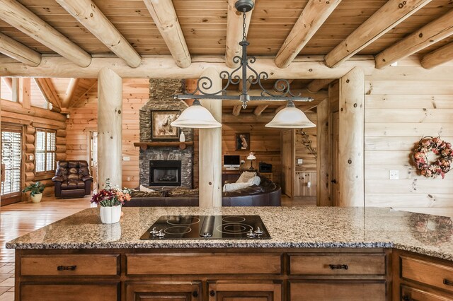 kitchen featuring beamed ceiling, light hardwood / wood-style floors, wooden ceiling, and black electric stovetop