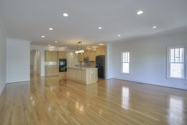 unfurnished living room featuring ornamental molding, light hardwood / wood-style floors, and sink