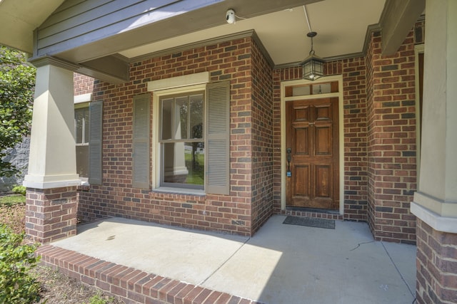 view of exterior entry with covered porch