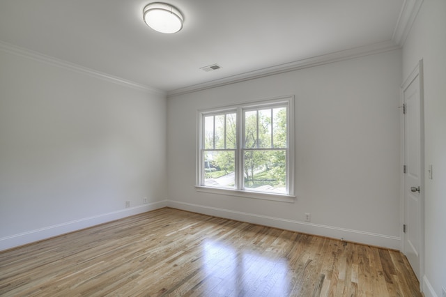 unfurnished room featuring crown molding and light hardwood / wood-style floors