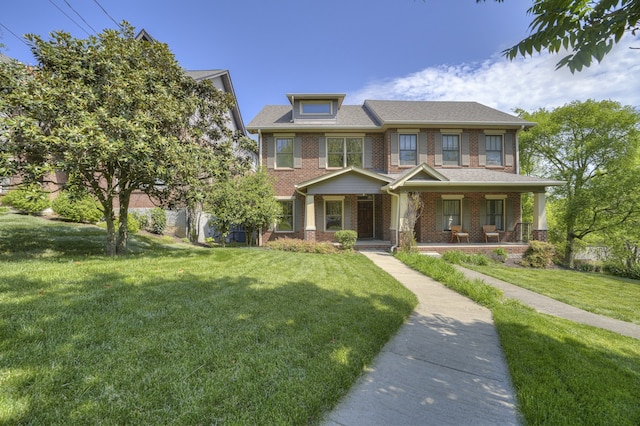 view of front of property with covered porch and a front yard