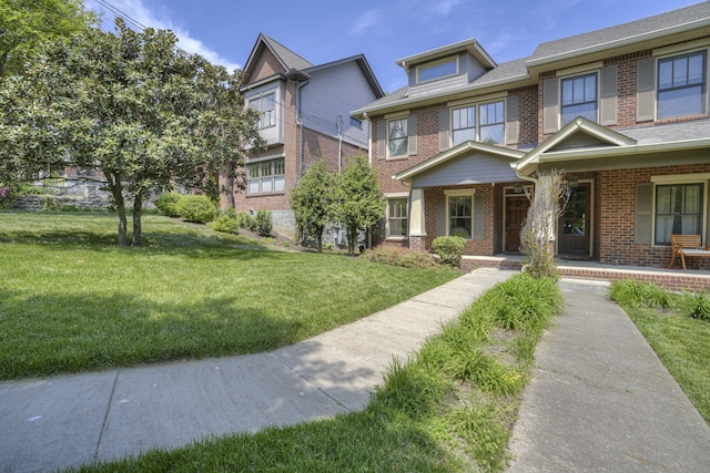 view of front of home with a porch and a front lawn