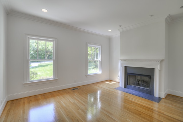 unfurnished living room with light hardwood / wood-style flooring and ornamental molding