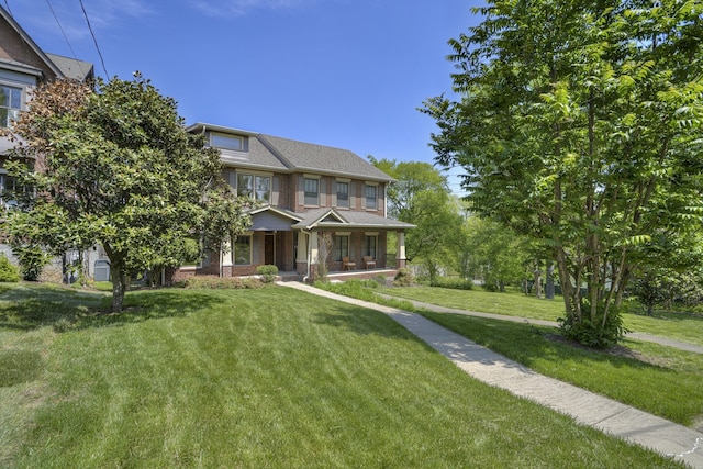 view of front of home with a front lawn and covered porch